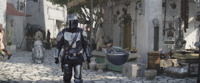 Din Djarin (Pedro Pascal) and Grogu in Lucasfilm's THE MANDALORIAN, season three, exclusively on Disney+. ©2023 Lucasfilm Ltd. & TM. All Rights Reserved.